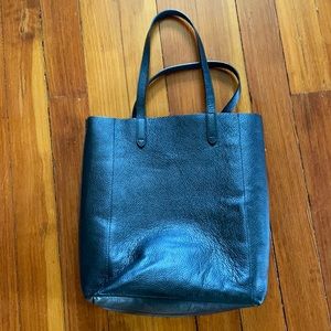 Black leather tote by Cuyana.